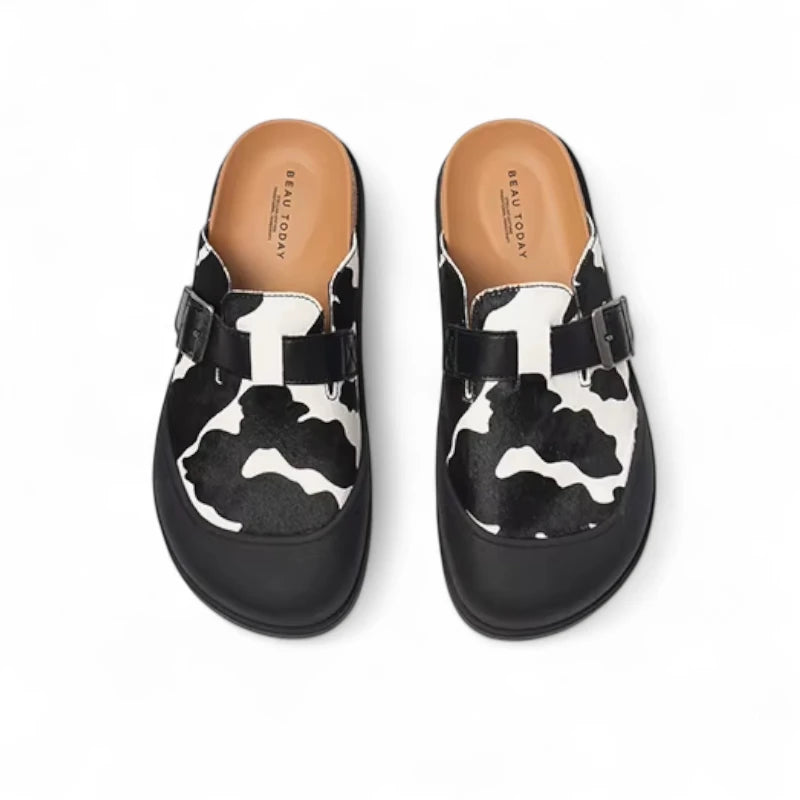 Mules Vache Noir et Beige pour femme vues de dessus, mettant en avant la doublure cuir et la forme anatomique.